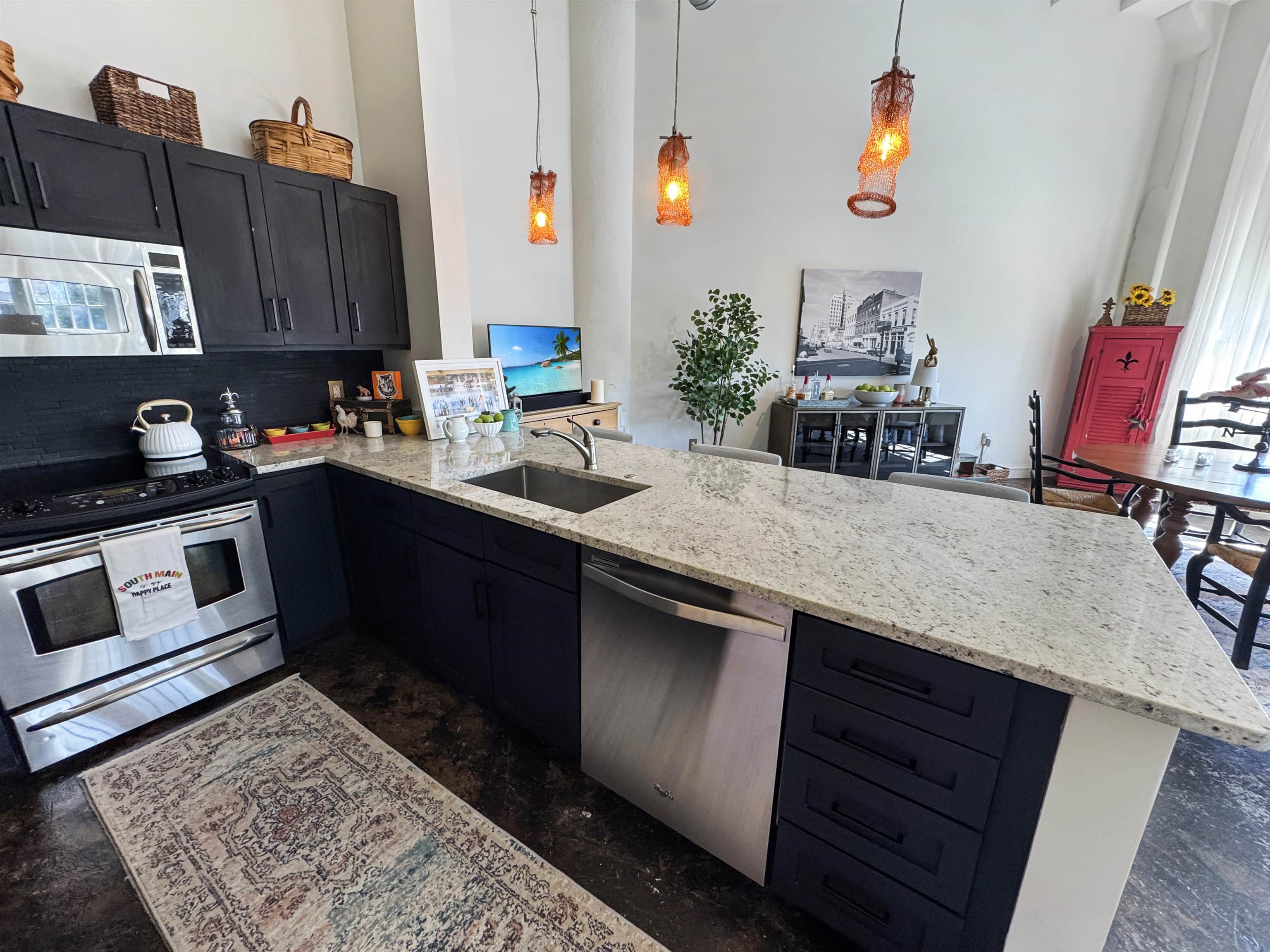 505 Tennessee Street, Unit 213 Memphis, TN 38103 - Photo 15 of 33 a kitchen with stainless steel appliances granite countertop a sink stove and cabinets
