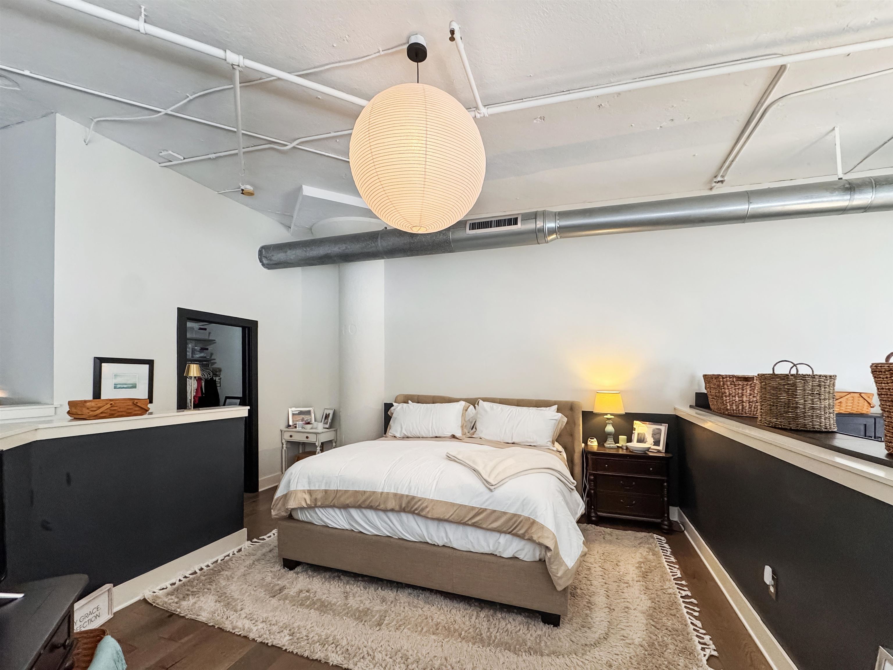 505 Tennessee Street, Unit 213 Memphis, TN 38103 - Photo 17 of 33 a bedroom with a bed and wooden floor