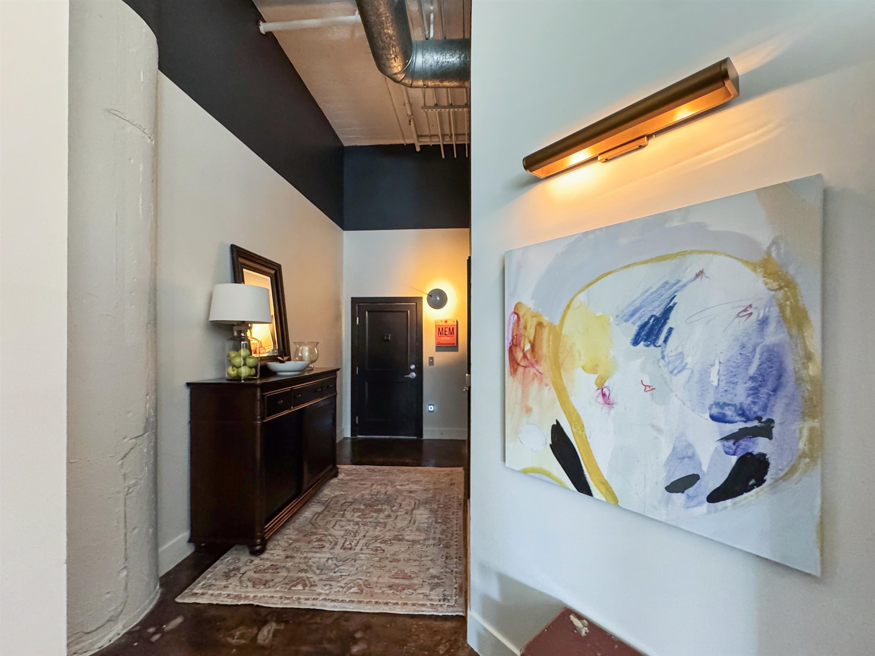 505 Tennessee Street, Unit 213 Memphis, TN 38103 - Photo 2 of 33 a view of a hallway with wooden floor and furniture