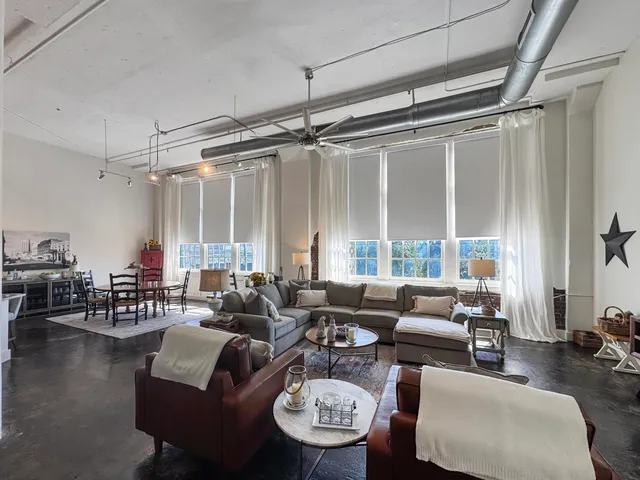 a living room with furniture a rug and a chandelier