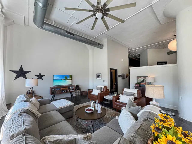 a living room with furniture and a large window