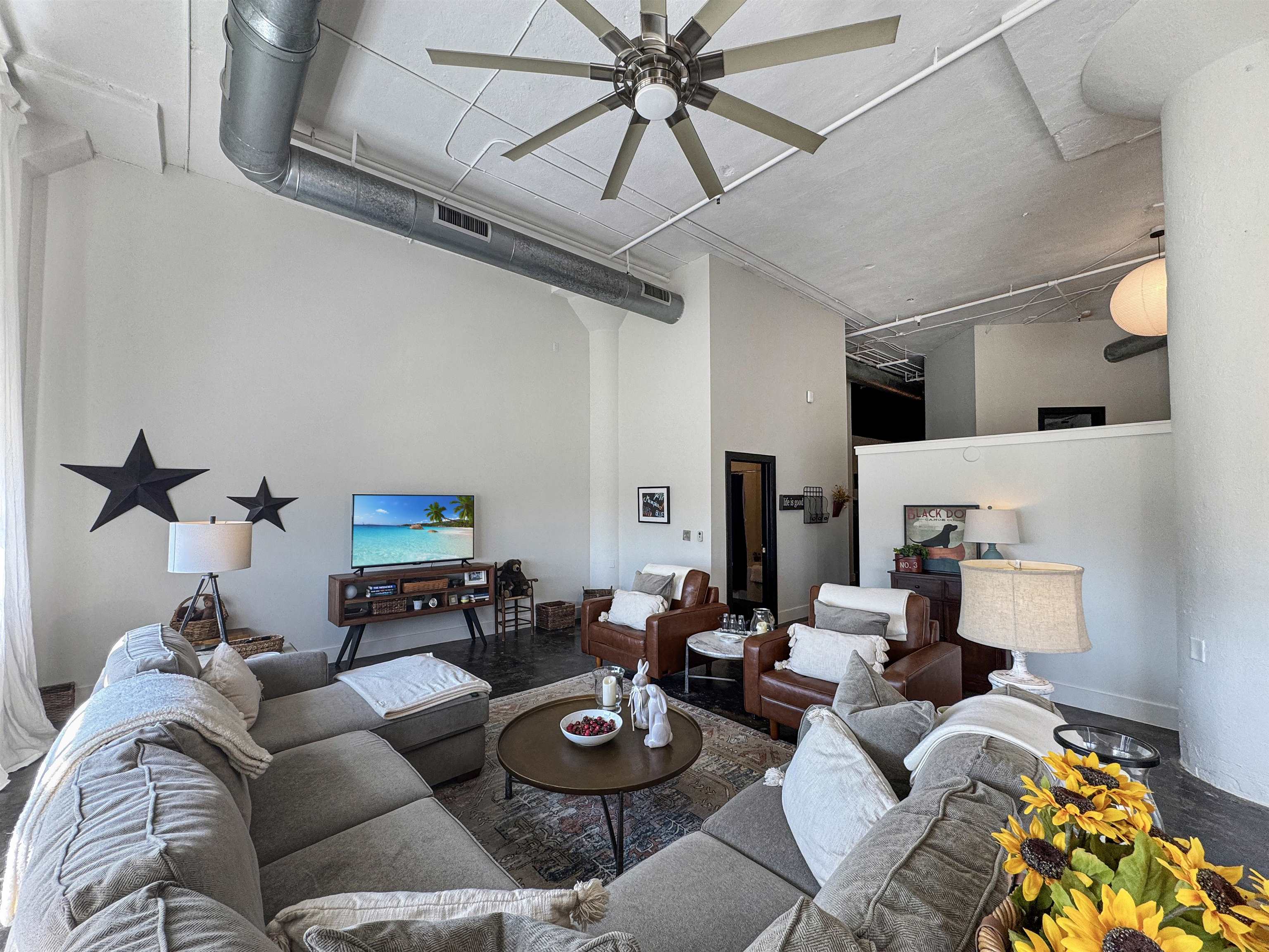505 Tennessee Street, Unit 213 Memphis, TN 38103 - Photo 7 of 33 a living room with furniture a rug and a chandelier