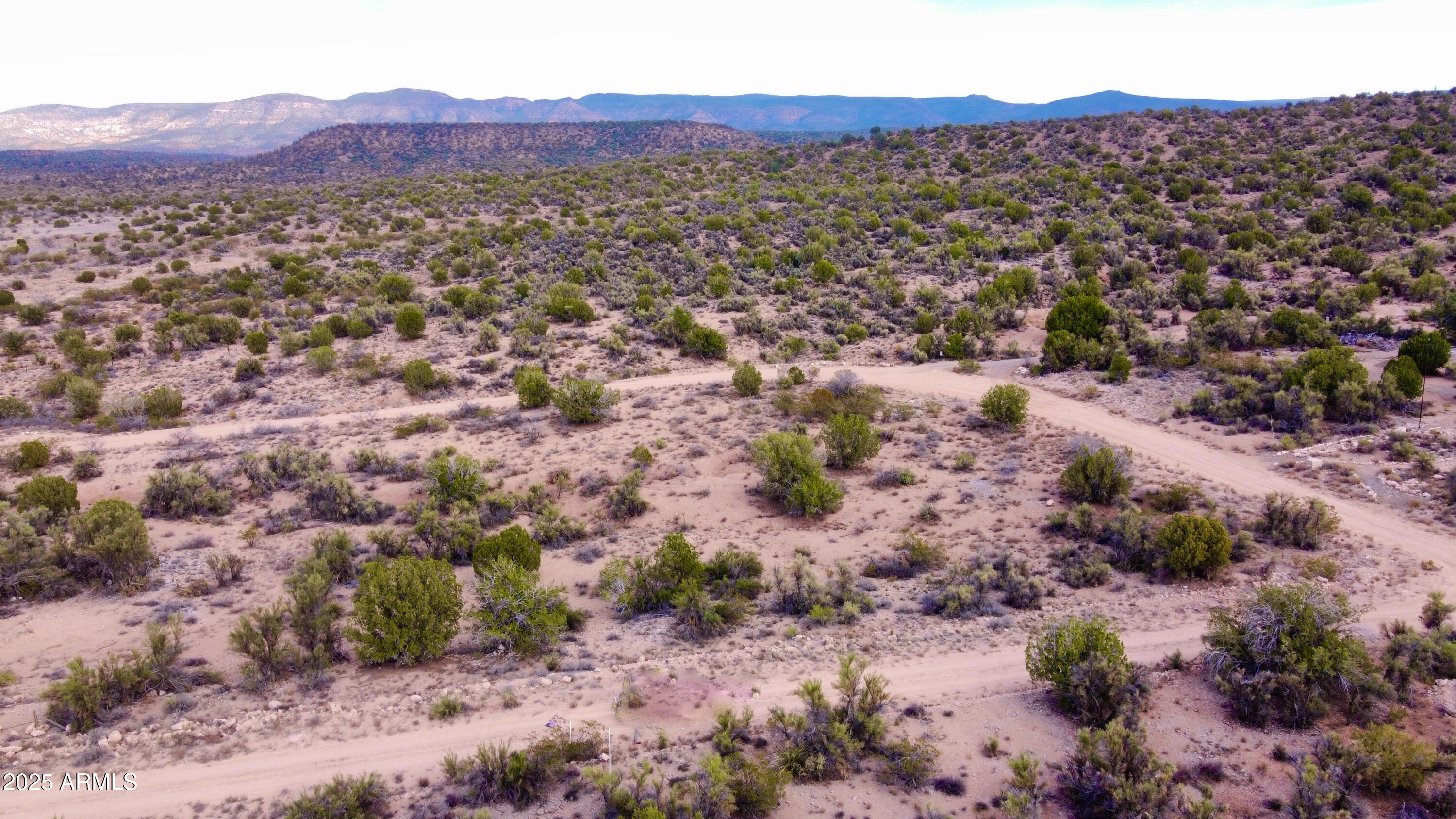 3075 Sonora Pass, Unit 65 Rimrock, AZ 86335 - Photo 2 of 17 a view of a lush green hillside and houses