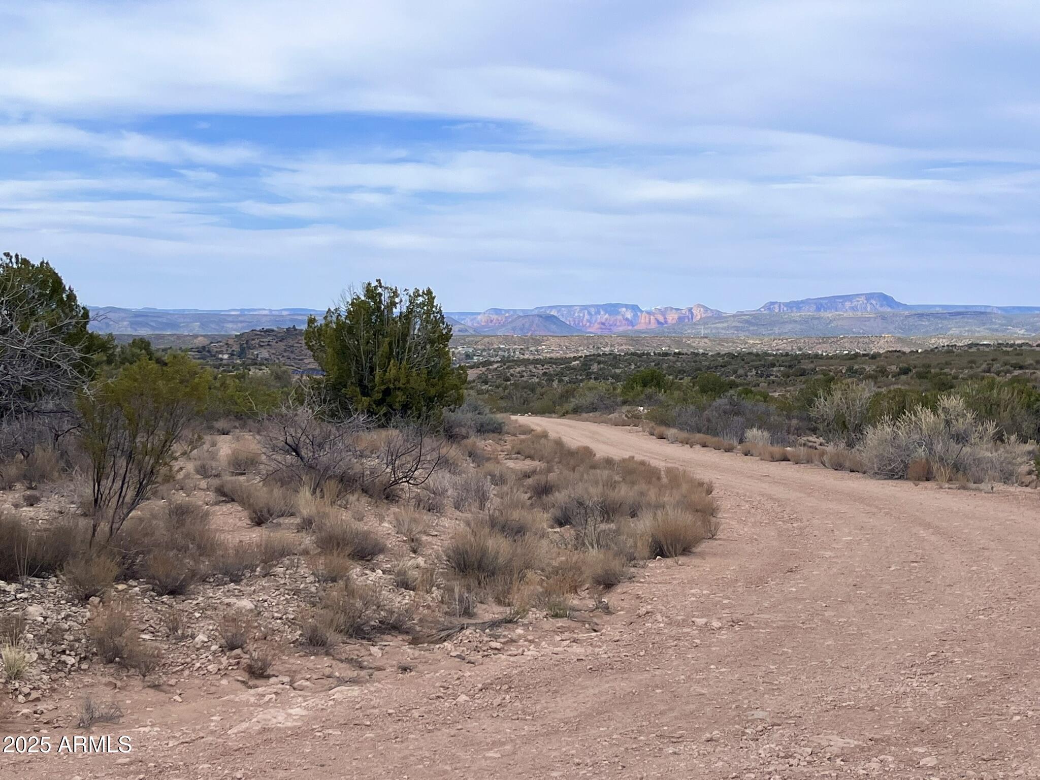 3075 Sonora Pass, Unit 65 Rimrock, AZ 86335 - Photo 6 of 17 a view of a dry yard with mountains in the background