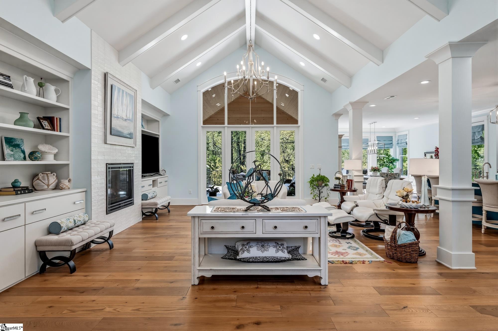 158 Tully Drive Anderson, SC 29621 - Photo 5 of 49 Architectural beam ceiling, wood flooring, custom built-in bookcases, gas fireplace with pearlescent tile surround.