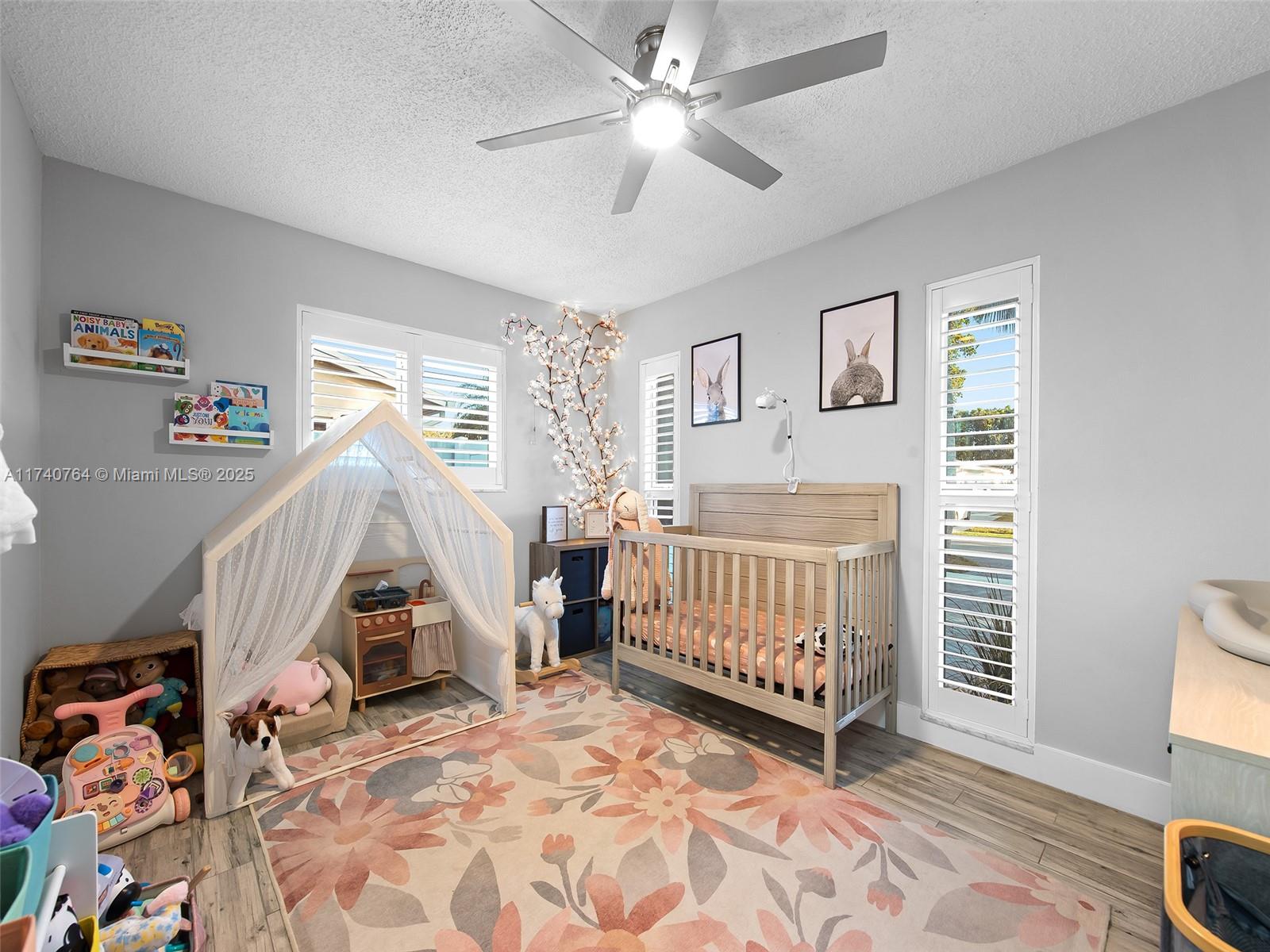 413 Southeast 4th Terrace Dania Beach, FL 33004 - Photo 15 of 25 a bedroom with a baby crib and a window