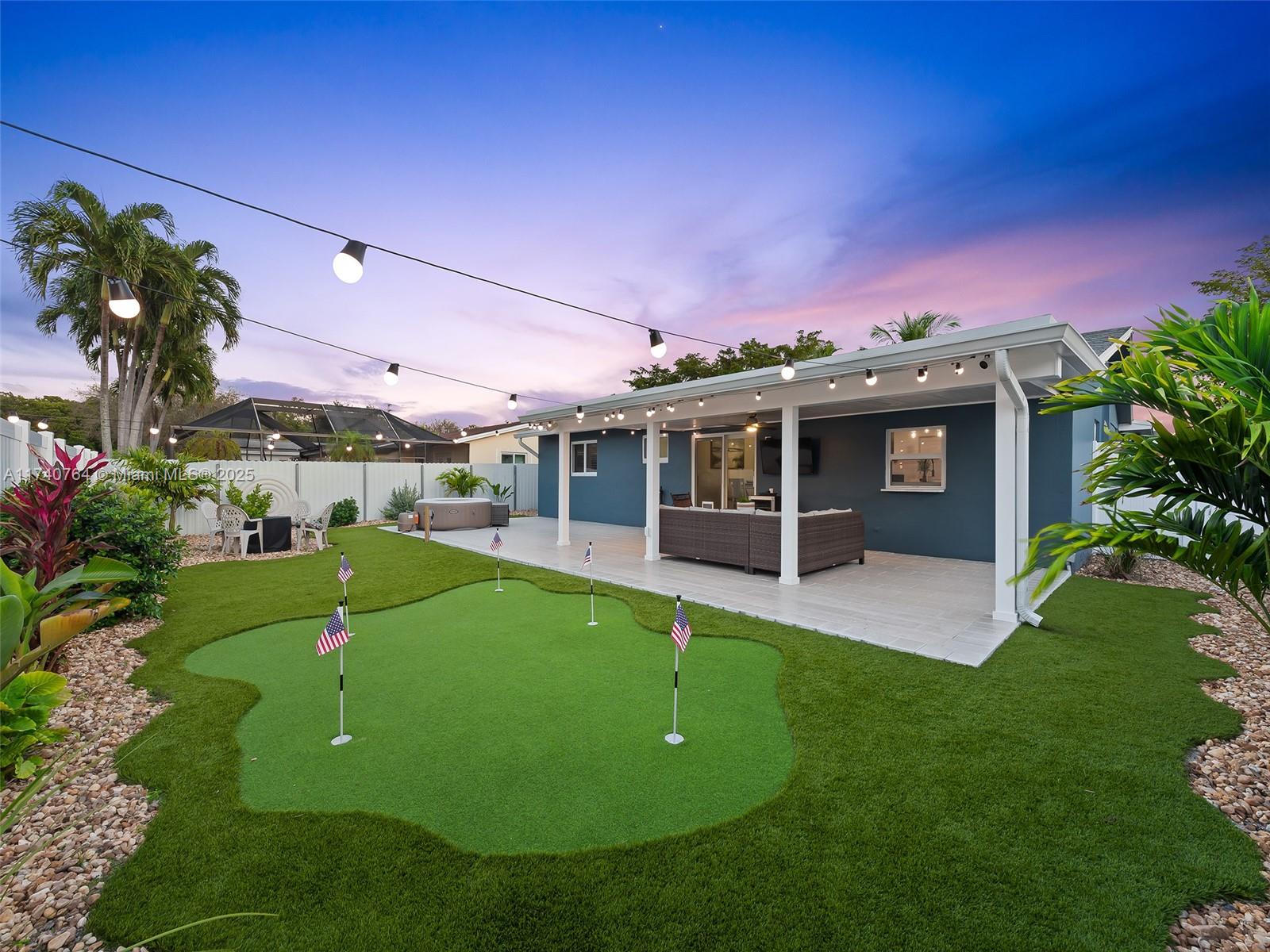 413 Southeast 4th Terrace Dania Beach, FL 33004 - Photo 3 of 25 a view of a house with a backyard and a patio