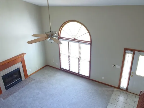 an empty room with windows dryer and fireplace
