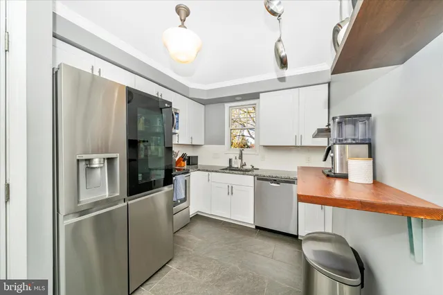 a kitchen with a sink a window and cabinets