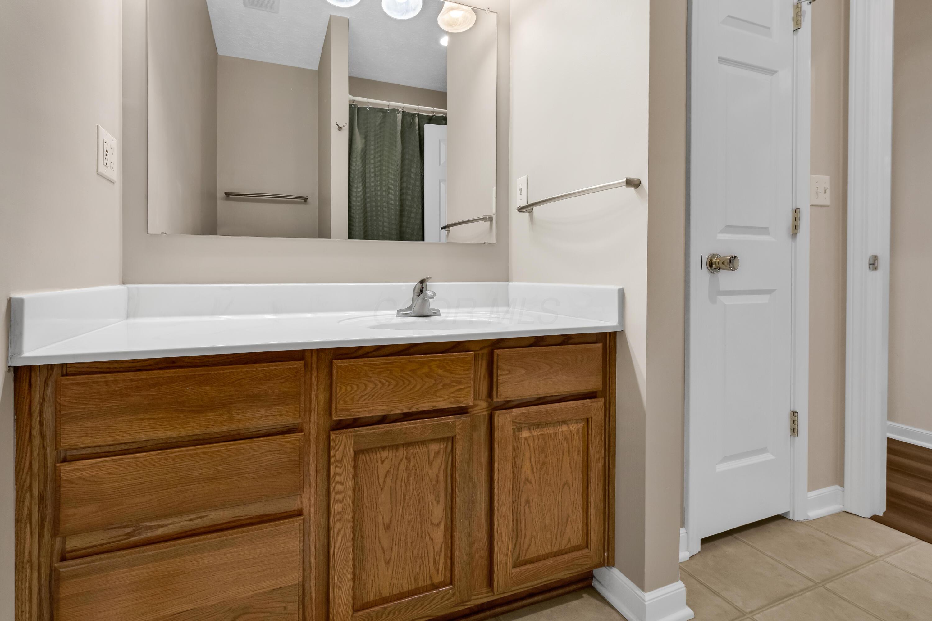 14396 Blamer Road Johnstown, OH 43031 - Photo 29 of 48 • Neutral vinyl flooring
• Tan painted walls
• Linen closet
• 5 bulb wall light
• Enclosed vanity with single
bowl, cultured marble sinktop
• Ceiling exhaust
• Tub/shower combination