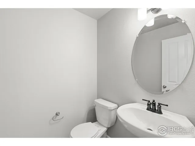 a bathroom with a sink mirror and toilet