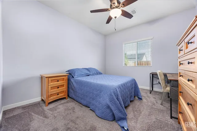 a bedroom with a bed and a desk