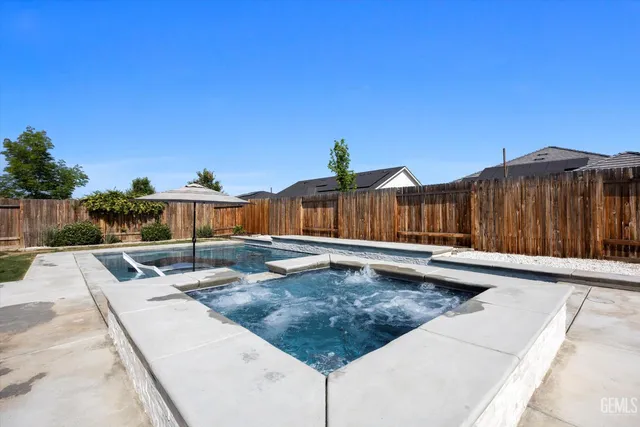 an aerial view of residential houses with outdoor space and seating area