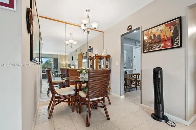 a dining room with furniture and a chandelier