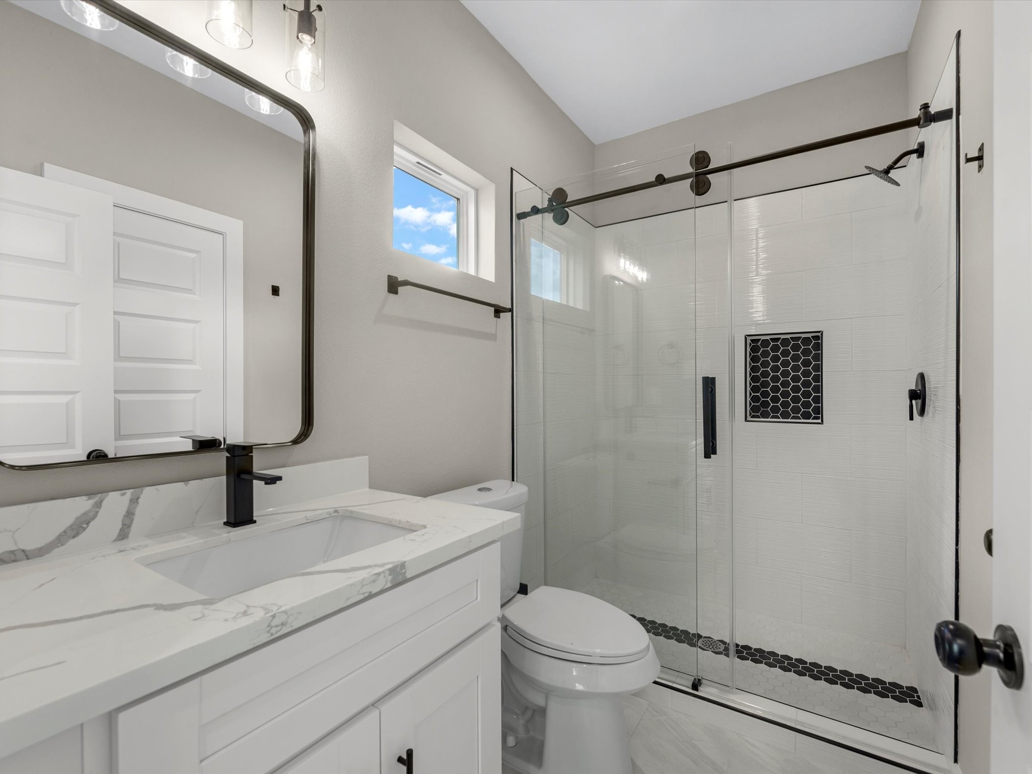 7802 Queen Street, Unit A Houston, TX 77028 - Photo 16 of 40 a bathroom with a sink toilet a mirror and shower