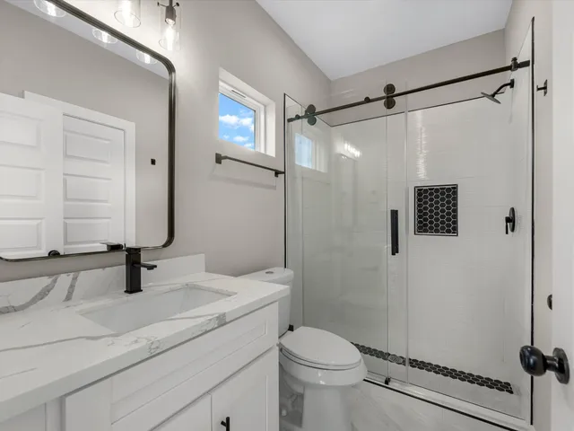 an empty room with a window and a ceiling fan