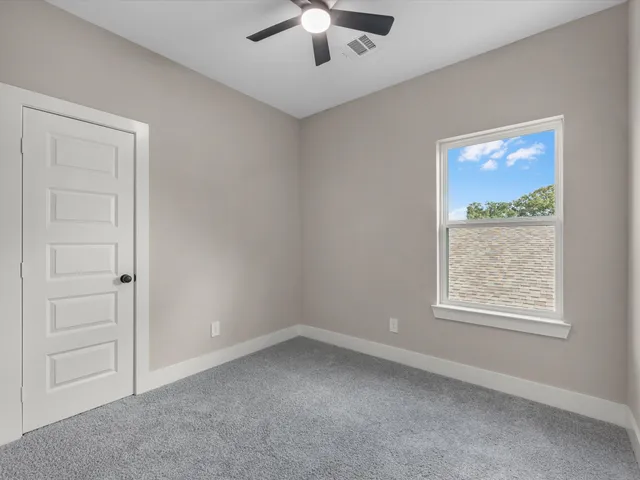 a bathroom with a shower sink vanity mirror and toilet