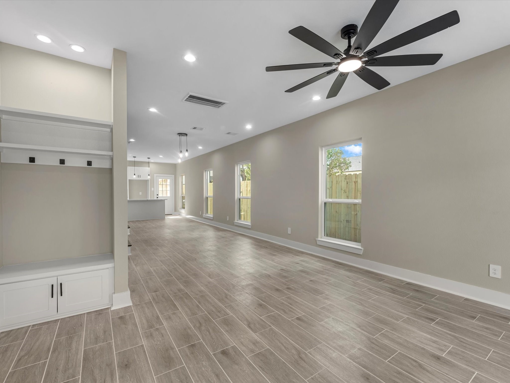 7802 Queen Street, Unit A Houston, TX 77028 - Photo 24 of 40 an empty room with wooden floor and windows