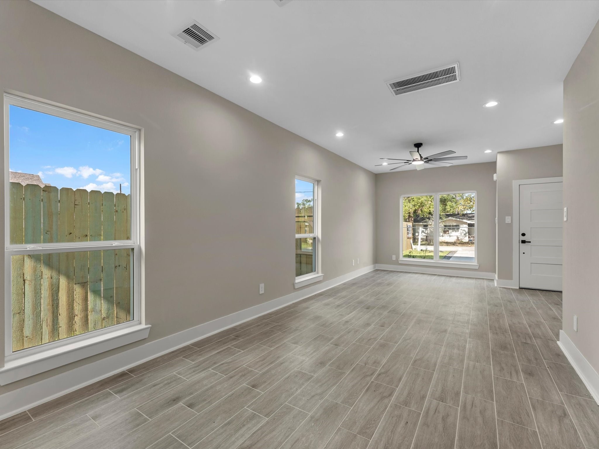 7802 Queen Street, Unit A Houston, TX 77028 - Photo 26 of 40 an empty room with wooden floor and windows