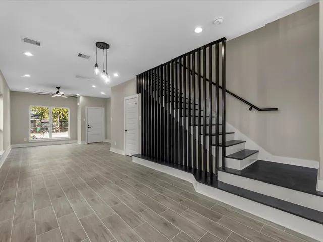 a kitchen with stainless steel appliances granite countertop a sink a stove and a refrigerator