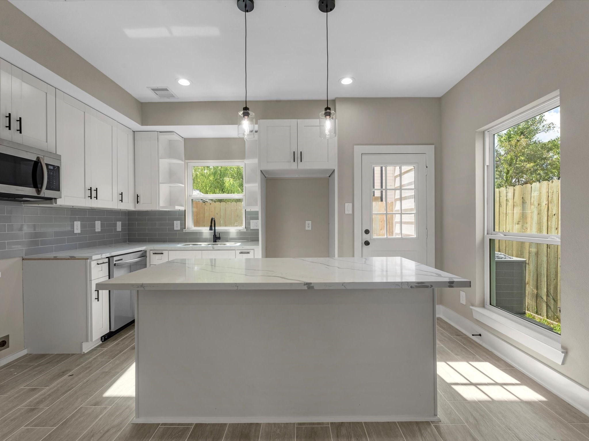 7802 Queen Street, Unit A Houston, TX 77028 - Photo 28 of 40 a kitchen with stainless steel appliances granite countertop a sink a stove and a refrigerator
