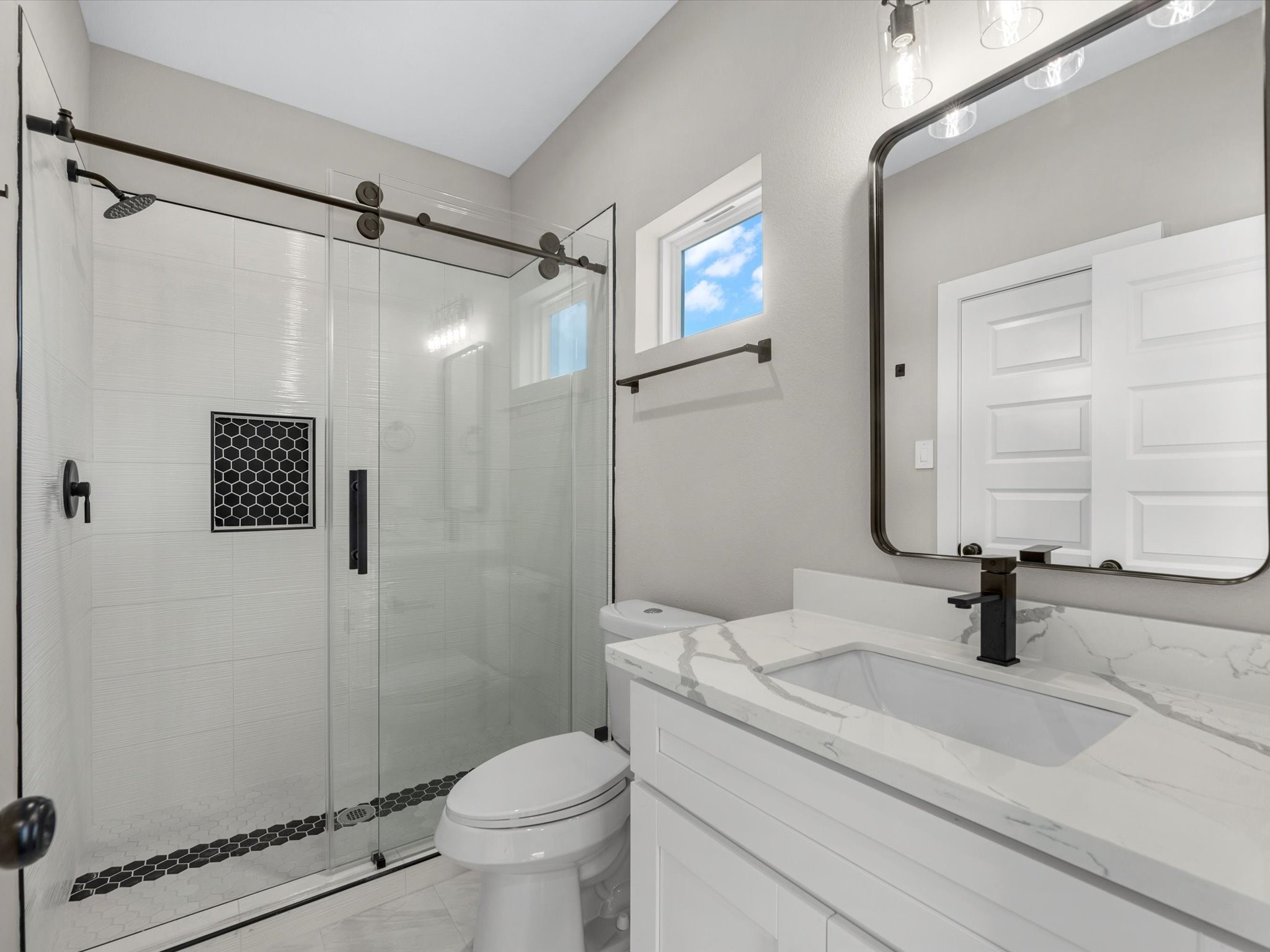 7802 Queen Street, Unit A Houston, TX 77028 - Photo 34 of 40 a bathroom with a granite countertop sink toilet and shower