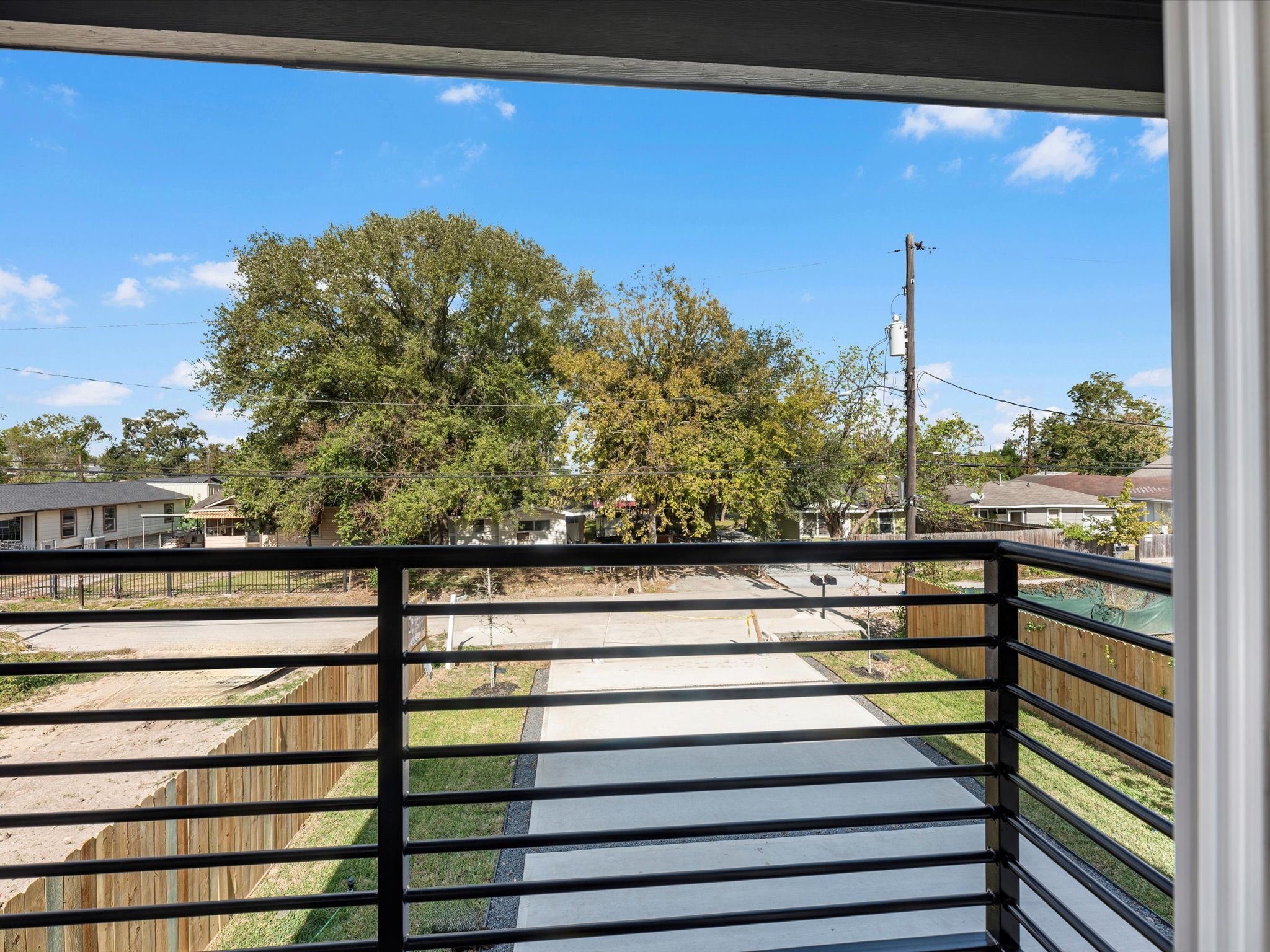 7802 Queen Street, Unit A Houston, TX 77028 - Photo 35 of 40 a view of a balcony with a floor to ceiling window next to a road