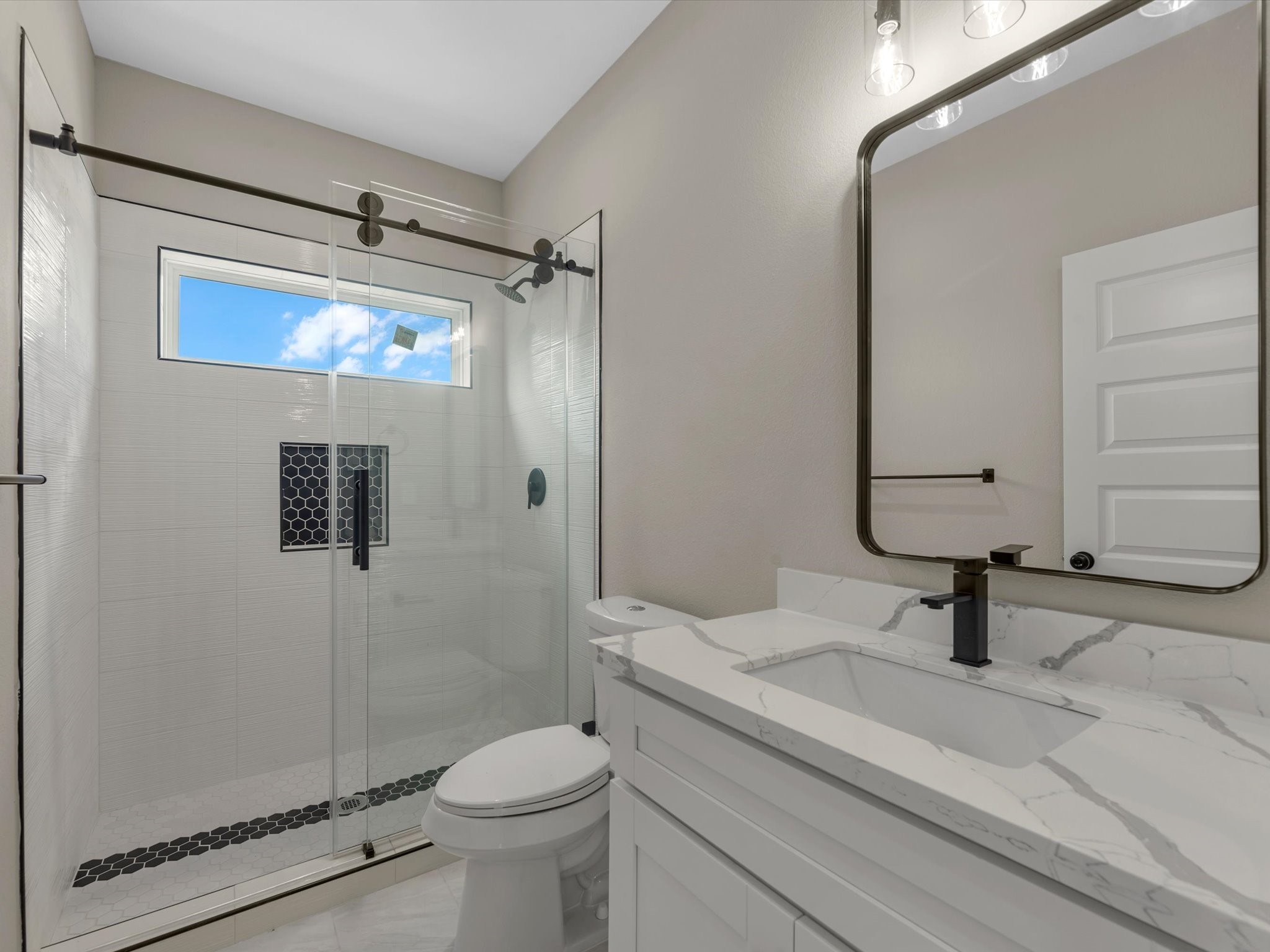 7802 Queen Street, Unit A Houston, TX 77028 - Photo 37 of 40 a bathroom with a sink a toilet and shower