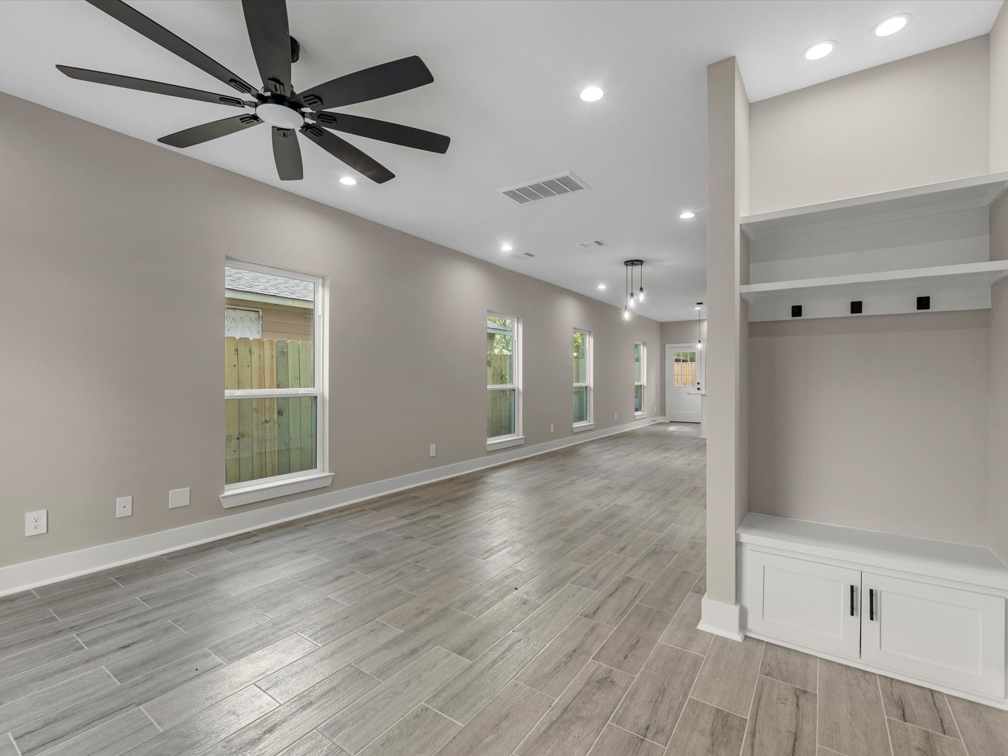 7802 Queen Street, Unit A Houston, TX 77028 - Photo 4 of 40 a view of an empty room with a window and wooden floor