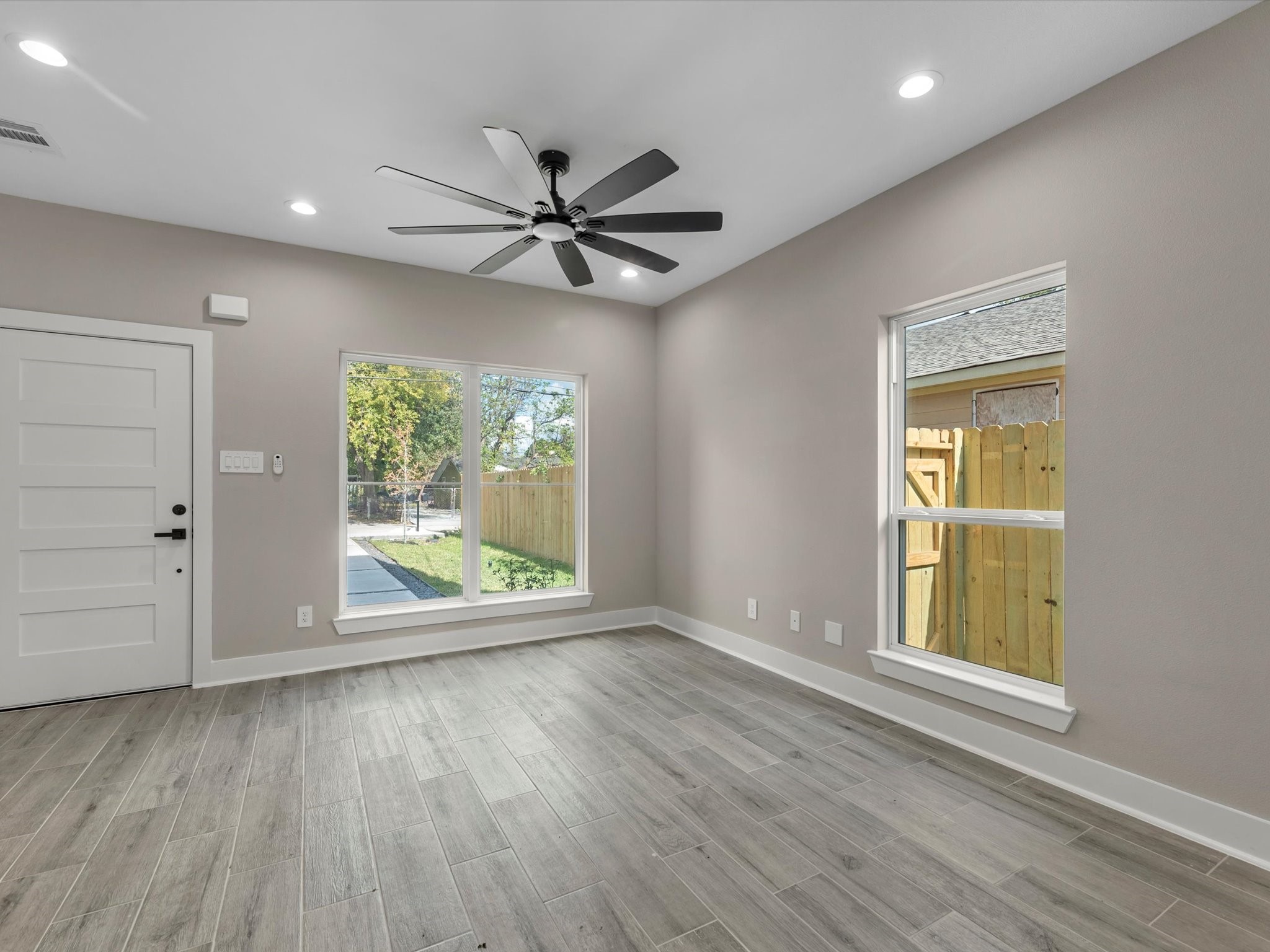 7802 Queen Street, Unit A Houston, TX 77028 - Photo 6 of 40 an empty room with wooden floor fan and windows