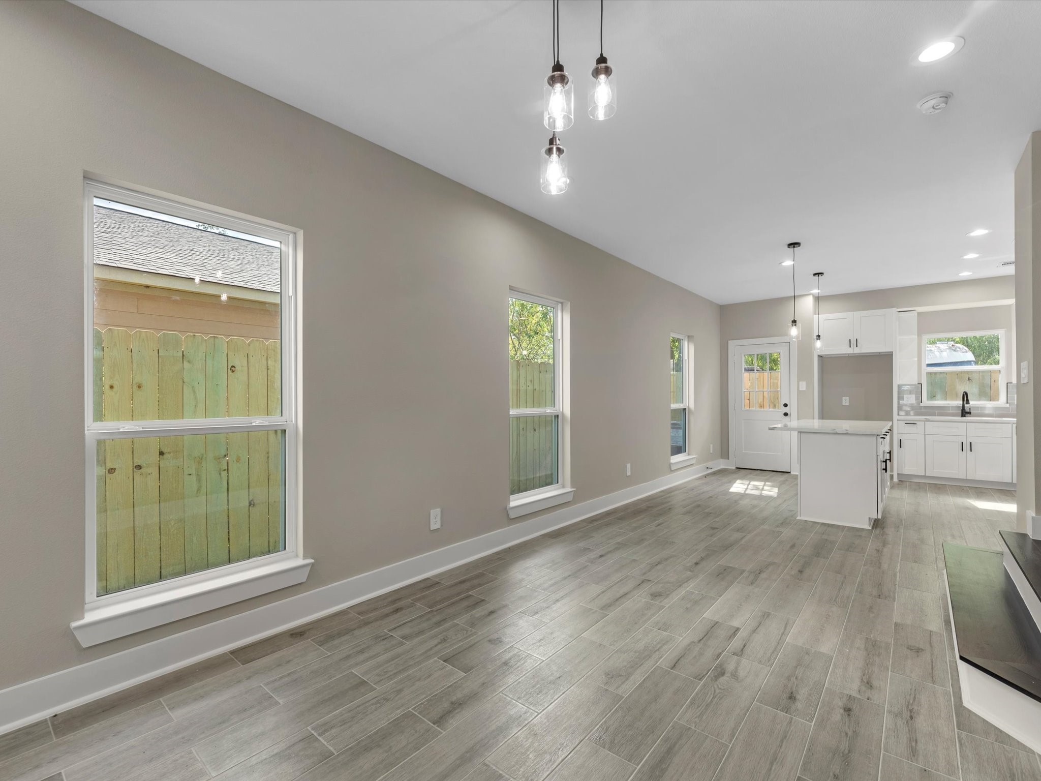 7802 Queen Street, Unit A Houston, TX 77028 - Photo 7 of 40 an empty room with wooden floor cabinet and windows