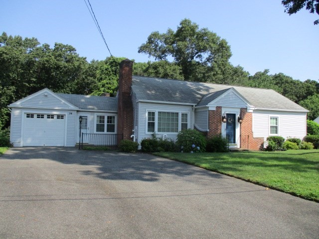 a front view of a house with a garden