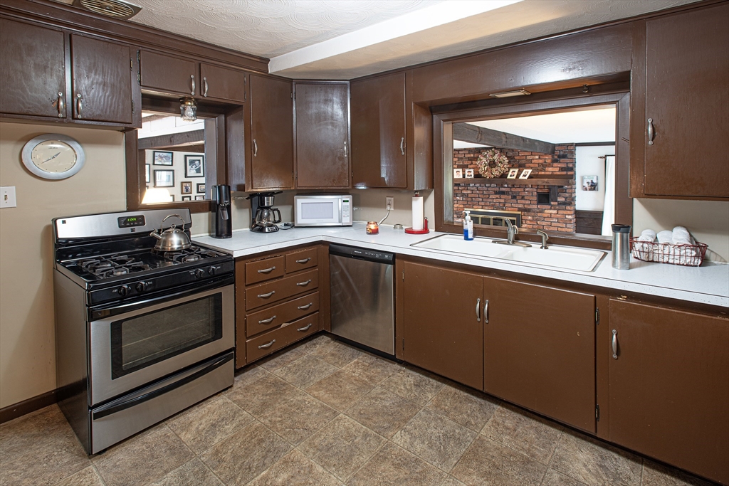54 South Shore Drive Springfield, MA 01118 - Photo 11 of 39 a kitchen with a sink stove and cabinets