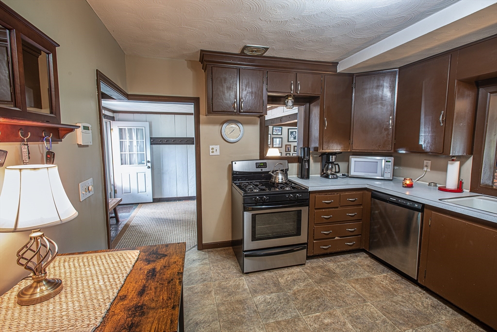 54 South Shore Drive Springfield, MA 01118 - Photo 12 of 39 a kitchen with stainless steel appliances granite countertop a stove a sink and a microwave