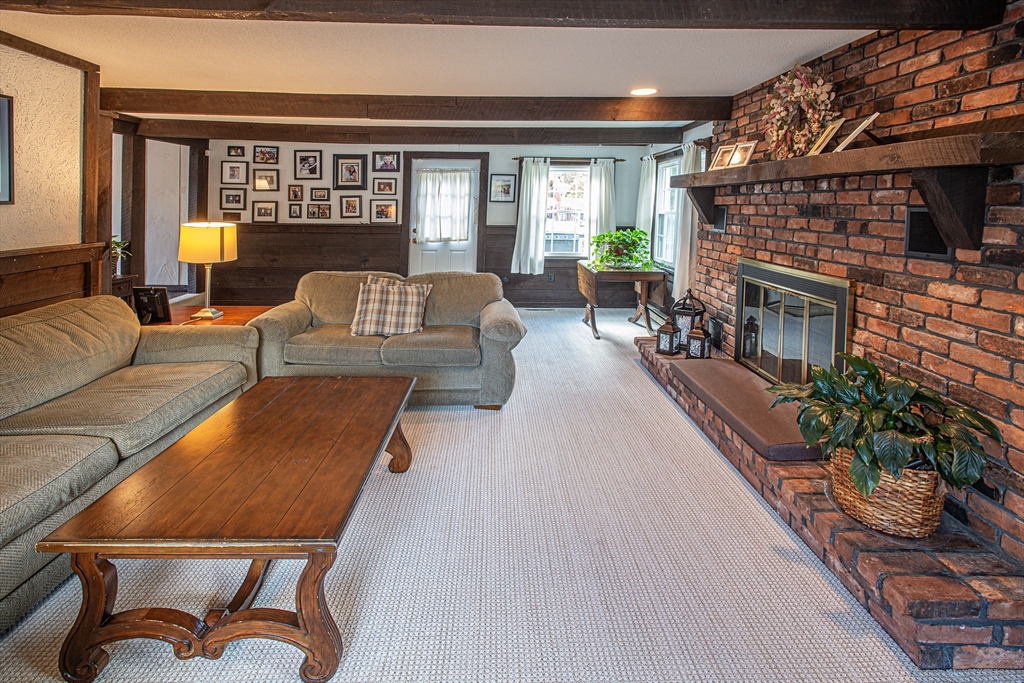 54 South Shore Drive Springfield, MA 01118 - Photo 18 of 39 a living room with furniture a fireplace and a potted plant