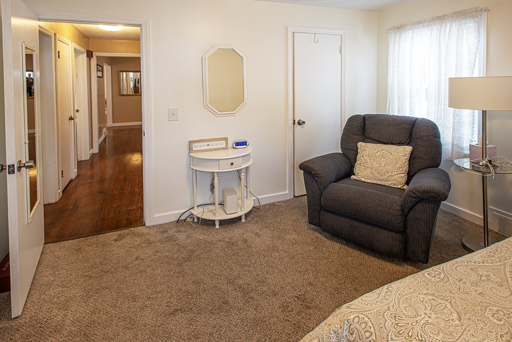 54 South Shore Drive Springfield, MA 01118 - Photo 27 of 39 a living room with furniture a mirror and a lamp