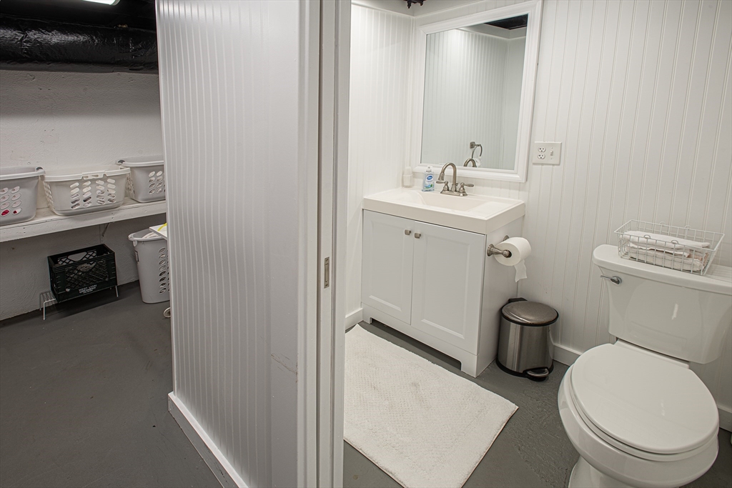 54 South Shore Drive Springfield, MA 01118 - Photo 30 of 39 a bathroom with a sink a toilet and a mirror