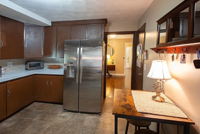 a kitchen with stainless steel appliances granite countertop a refrigerator a sink and a stove