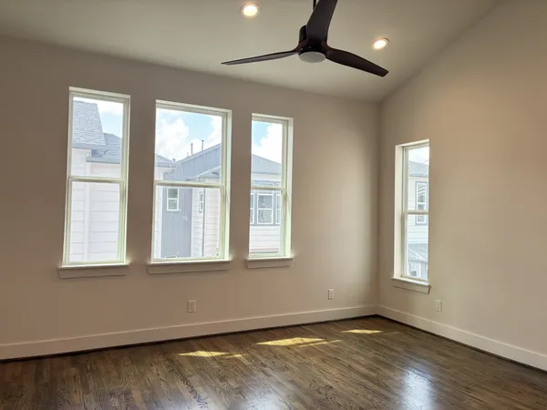 a view of an empty room and wooden floor