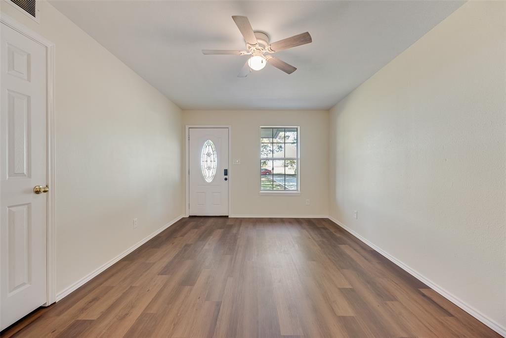 751 County Road 1240 Mount Pleasant, TX 75455 - Photo 11 of 35 an empty room with wooden floor and windows
