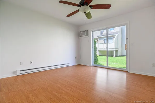 wooden floor in an empty room with a window