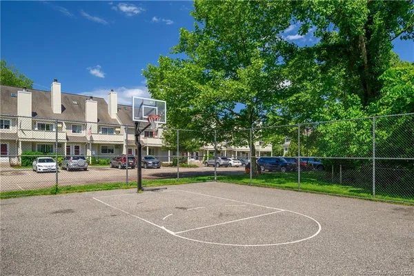 a view of a playground with basketball court