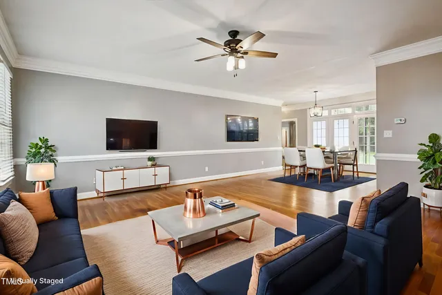 a view of a living room and kitchen with furniture