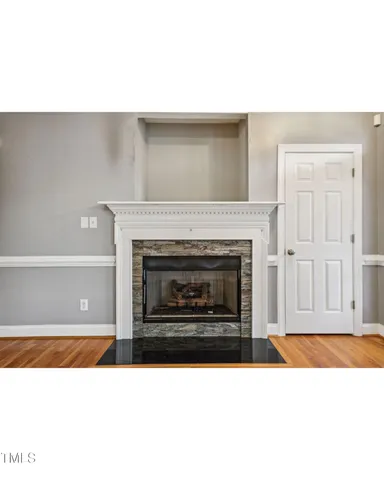a black and white photo of a fireplace