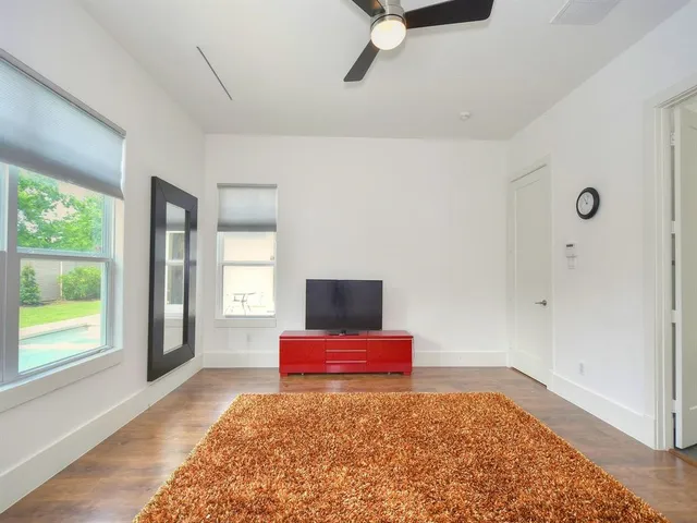 a view of a livingroom with wooden floor and windows