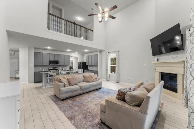 a living room with furniture a fireplace and a flat screen tv