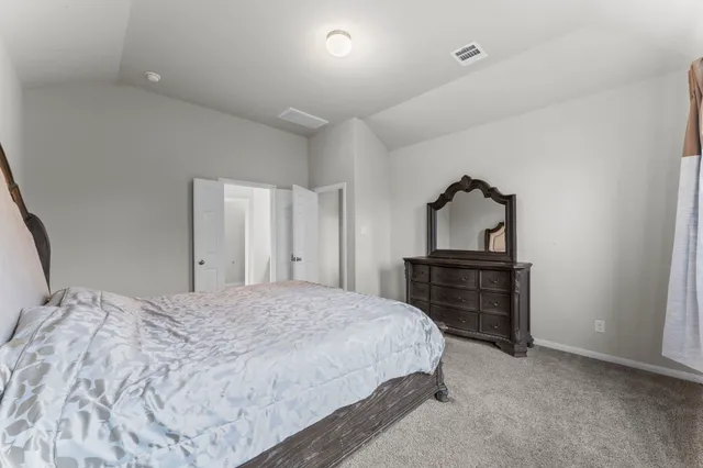 a bedroom with a bed and a dresser