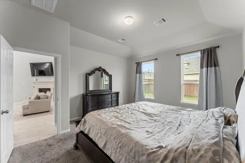 a bedroom with a bed and a large mirror