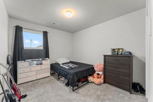 a bedroom with a bed and a flat tv screen