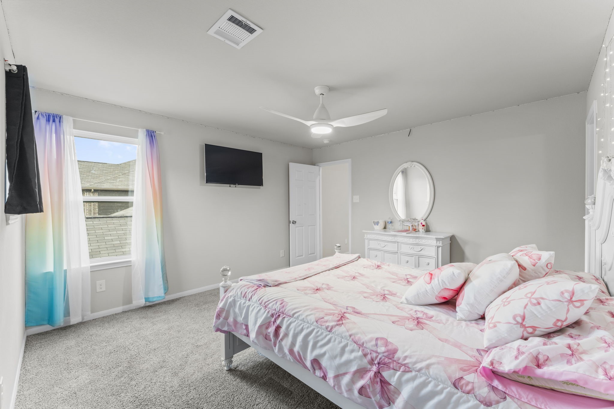 11331 Painted Trillium Lane Houston, TX 77044 - Photo 30 of 38 a bedroom with a bed and a flat screen tv